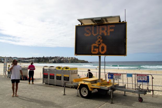 Sydney, NSW, Australia, April 28, 2020. Sign indicating that the beach is open again for surfing but not lingering
