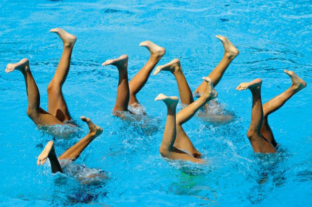 Synchronised swimmers&#039; legs in pool