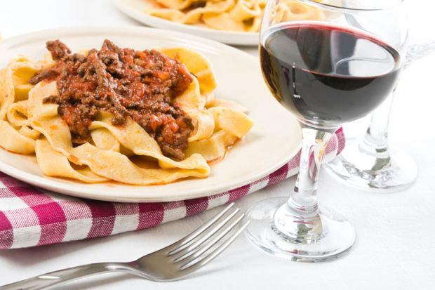 Tagliatelle with bolognese sauce and glass of red wine