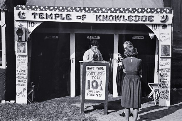 Historical photo of a fortune teller's booth, the Temple of Knowledge, showing advertising posters, admission taker, and two women customers waiting their turns. To illustrate that admissions on predicted A-level grades look foolish in AI era. Historical photo of a fortune teller's booth, the Temple of Knowledge, showing advertising posters, admission taker, and two women customers waiting their turns. To illustrate that admissions on predicted A-level grades look foolish in AI era.