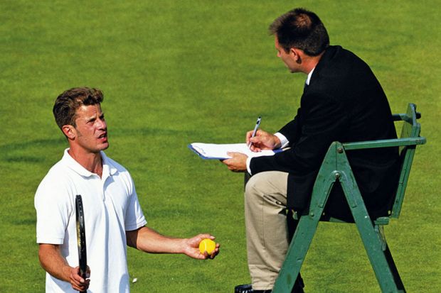 tennis player talks to umpire