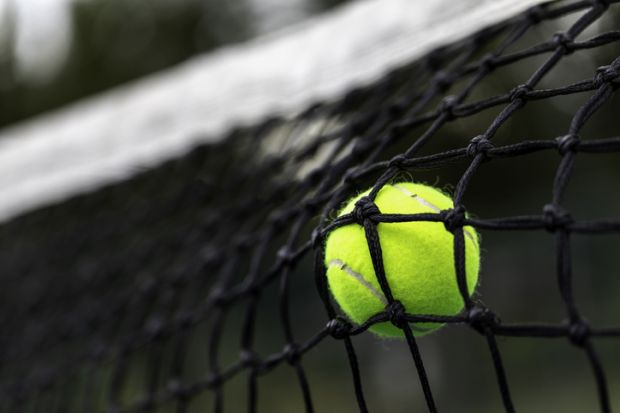 Tennis ball hitting the net for a fault