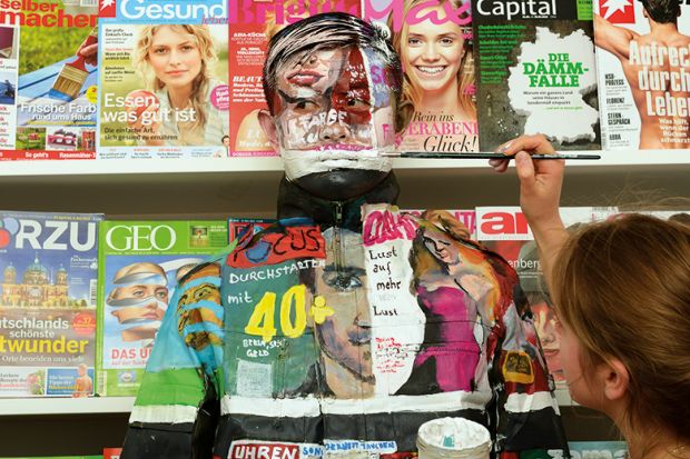 man being painted to blend in