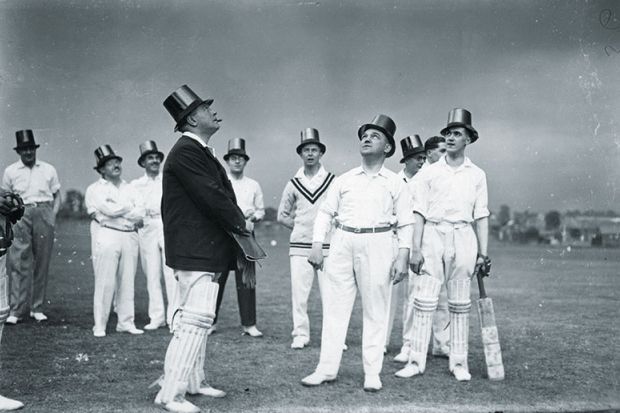 Cricket players wearing top hats