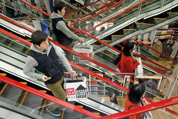 Shoppers on escalator in Tokyo