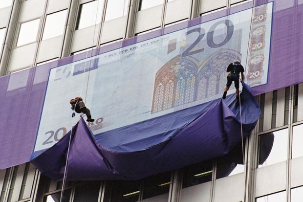 giant Euro note being unveiled by abseilers. Money
