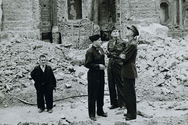 So-called Monuments Men inspecting a destroyed monument
