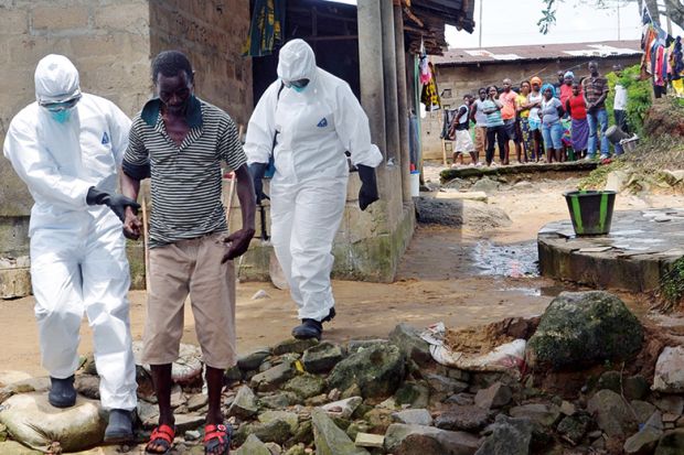 Nurses escort a man infected with the Ebola virus to a hospital