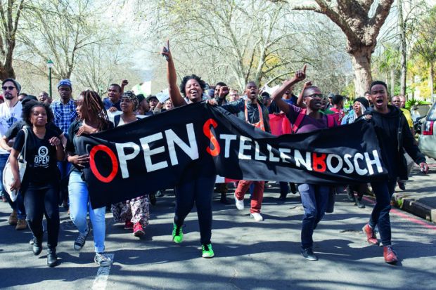 A group of students shout slogans and hold banners at Stellenbosch University in Cape Town, South Africa