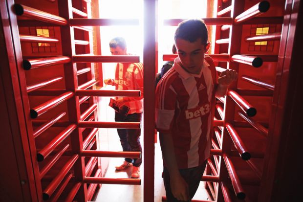 Supporters enter the ground through the turnstiles prior to the Barclays Premier League match between Stoke City and Norwich City at the Britannia Stadium in Stoke on Trent, England