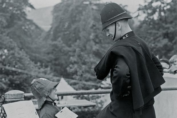 Policeman and boy wearing police costume