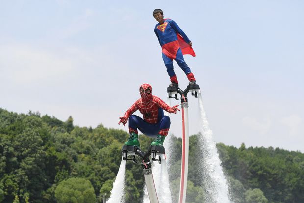 Motorboat athletes dressed as superman and spiderman compete on Tongsheng Lake on July 14, 2017 in Changsha, Hunan Province of China