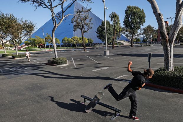 Long Beach, CA, Monday, September 29, 2020 - man skateboards in an empty parking lot at Cal State Long Beach where five students tested positive for Covid-19.