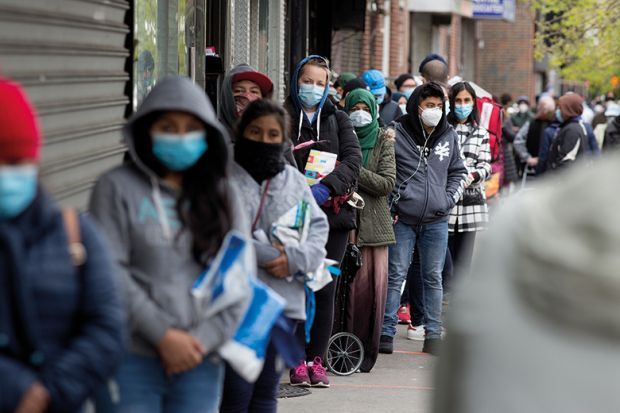 Citizens wearing protective masks form lines to receive free food from a food pantry run by the Council of Peoples Organization on May 8, 2020 in the Midwood neighborhood of Brooklyn, New York.