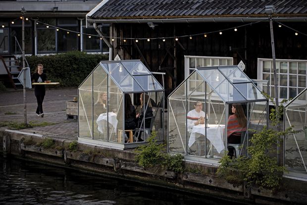 People have dinner in a so-called quarantine greenhouses in Amsterdam, on May 5, 2020 as the country fights against the spread of the COVID-19, the novel coronavirus.