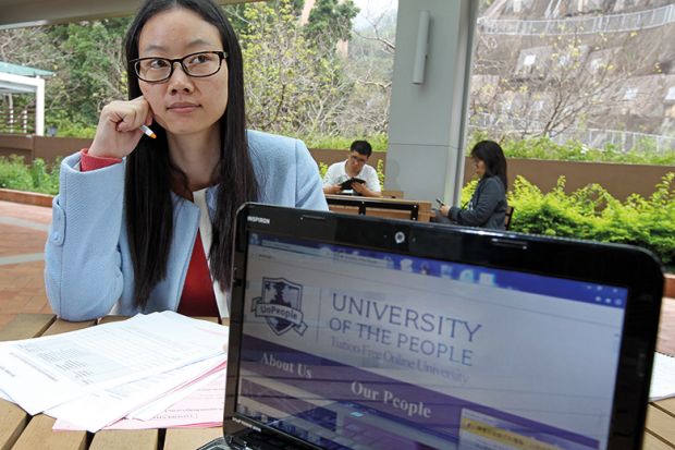 Woman poses with the website of the University of the People in Pok Fu Lam