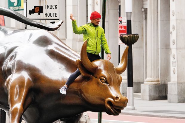 A person can be seen riding the Charging Bull in the financial distrcict  of New York City amid Coronavirus pandemic on April 5, 2020.