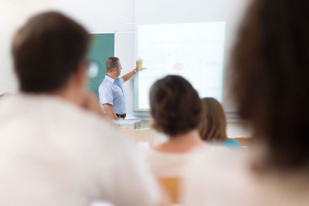 Trainee teachers studying in classroom