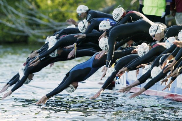 Triathlon swimmers at the start of a race