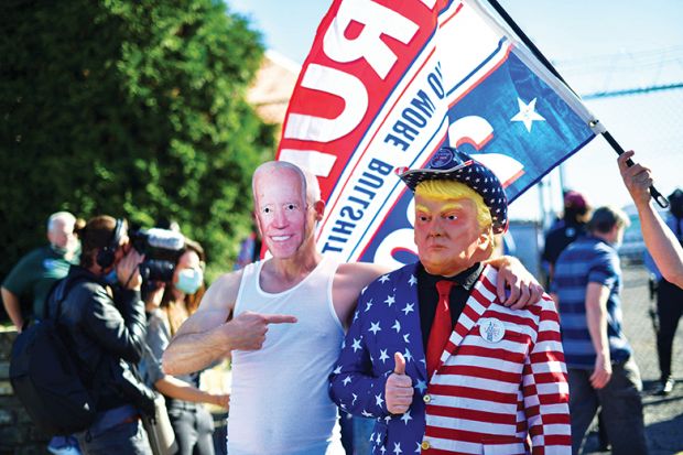 Trump supporters wearing a cardboard cut out of Democratic presidential nominee Joe Biden and a mask of Donald Trump embrace after Biden named winner in the 2020 U.S. presidential election, Philadelphia