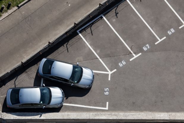 Two similar silver cars parked on one place