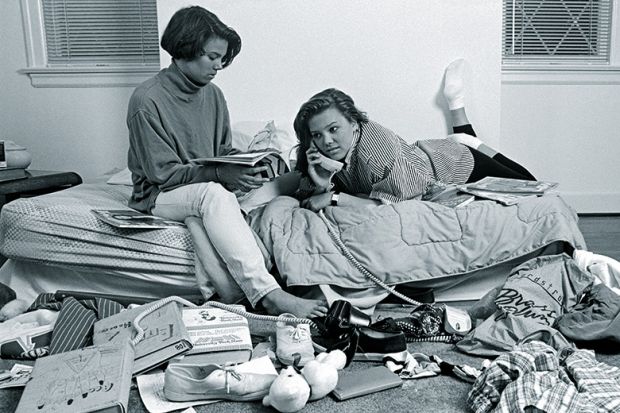 Two teenage girls in a messy bedroom