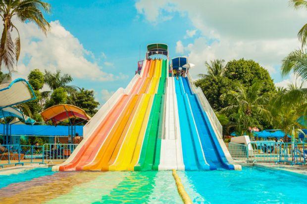 Unidentified people play slide at Siam Park City water park