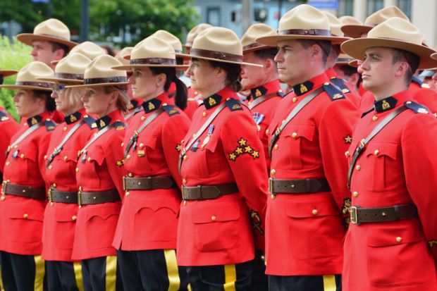 Victoria BC,Canada,June 10th 2014. RCMP police stand at attention as they honour fellow officers who gave their lives while on duty.
