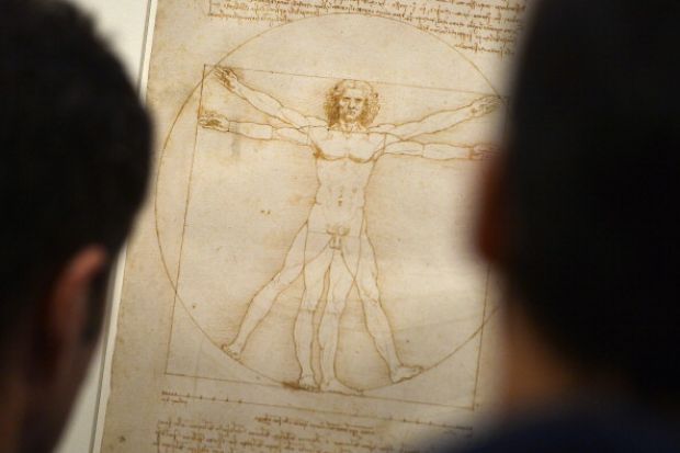 People look at the "Vitruvian Man" a drawing by Leonardo da Vinci, illustrating the combination of arts and science