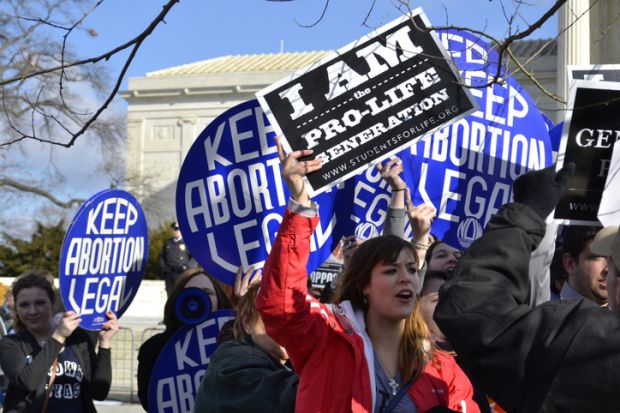 Washington D.C., USA, 22 January, 2015: pro-life woman clashes with pro-choice demonstrators at the U.S. Supreme Court