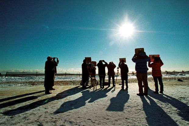Group of people watching eclipse in Canada Group of people watching eclipse in Canada