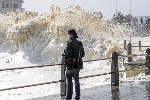 Strong winds blow large puffs of foam off the sea and into the streets of Sea Point in 2020 in Cape Town, South Africa