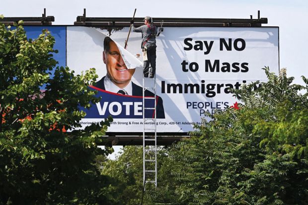 A worker removes a billboard featuring the portrait of People’s Party of Canada (PPC) leader Maxime Bernier A worker removes a billboard featuring the portrait of People’s Party of Canada (PPC) leader Maxime Bernier to illustrate Canadian universities fear loss of consensus on global role