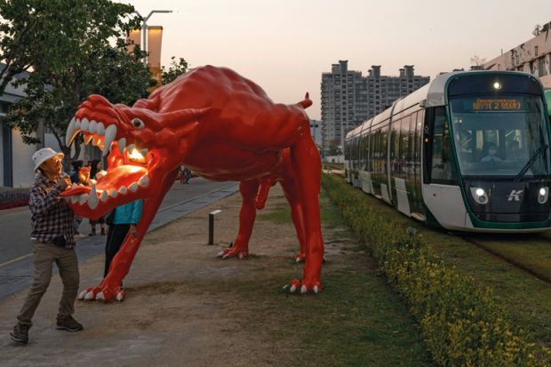 Dragon art installation outside the area of the Pier-2 Art Center in Kaohsiung, Taiwan with trams passing through Dragon art installation outside the area of the Pier-2 Art Center in Kaohsiung, Taiwan with trams passing through to illustrate China ‘intimidating’ international academics travelling to Taiwan