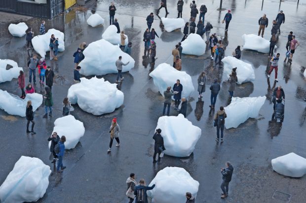 Visitors interact with blocks of melting ice from an exhibit outside Tate Modern in central London Visitors interact with blocks of melting ice from an exhibit outside Tate Modern in central London to illustrate A measure of reality