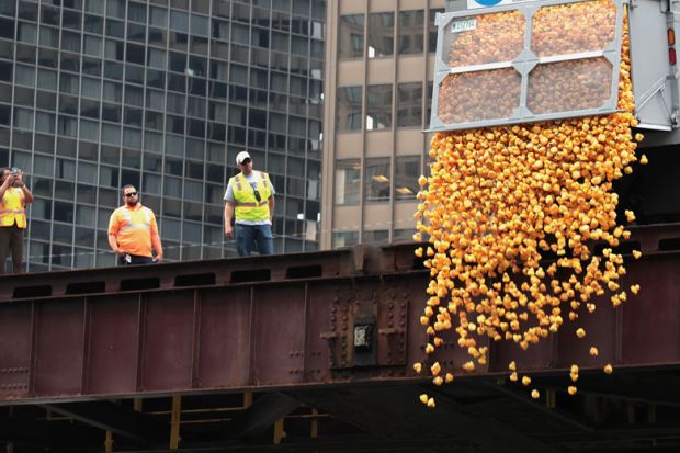  Rubber ducks are dropped into the Chicago River to illustrate Mounting debt poses threat to mission, Chicago warned