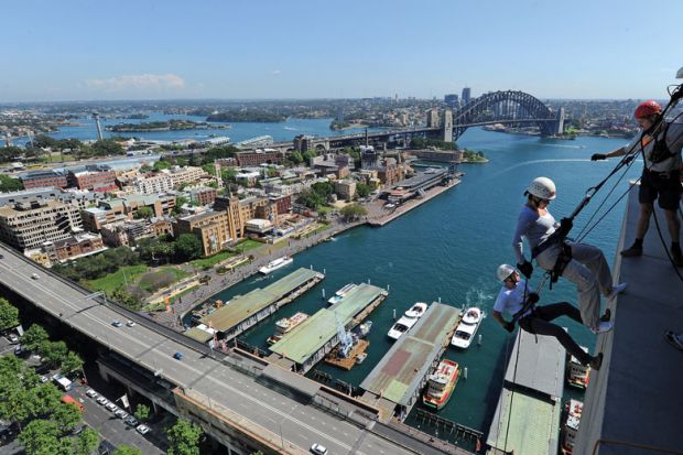 Two people abseil down the side of the Australian insurance and financial giant AMP's headquarters in Sydney to illustrate Elite university diversity drive raises Australian eyebrows