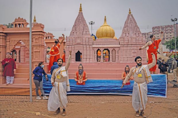 Artists perform in front of a replica of Kashi Vishwanath Dham Corridor to illustrate India’s fake universities proliferate as demand outstrips supply