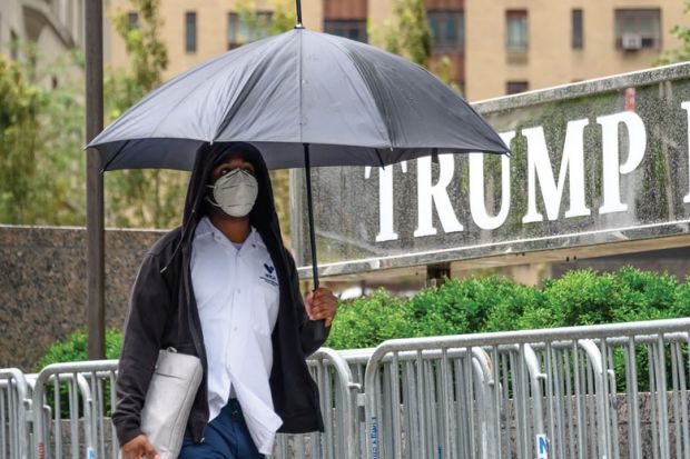 A person wears a protective face mask outside Trump International Hotel & Tower New York A person wears a protective face mask outside Trump International Hotel & Tower New York
