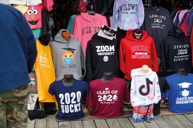  Tourists shop for boardwalk t-shirts including "ZOOM UNIVERSITY," "SOCIAL DISTANCING," and "2020 SUCKS" to illustrate Leading US universities settle Covid online teaching lawsuits