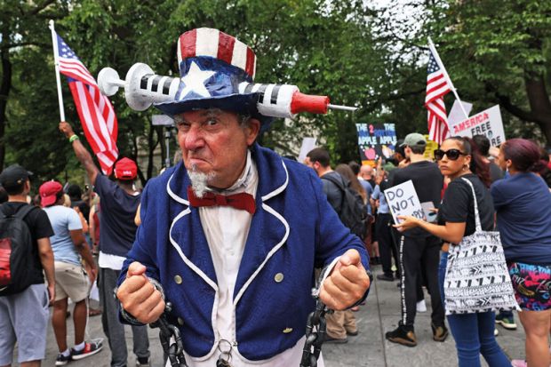 Person dressed as Uncle Sam with Vaccine American hat as metaphor for US partisan divide over Covid splitting apart campuses