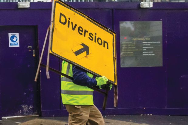 Workman moves a road diversion sign Fee freeze ‘risks exacerbating’  shift away from UK undergraduates