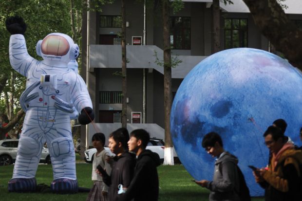 Inflatable models of astronaut and the Moon are on display to illustrate China expands Double First Class universities list