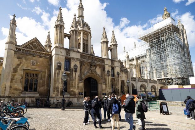 A tour guide speaks to tourists outside the entrance to King's College, University of Cambridge, in Cambridge to illustrate Cambridge growth plan ‘backs up UK science superpower vision’