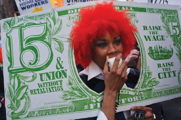 Person with red wig dressed as a fake banknote as a metaphor for US colleges face tougher scrutiny on graduate employment