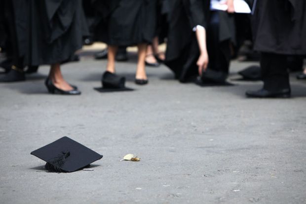 Students pick up their mortarboards from the ground to illustrate QAA’s exit leaves English sector ‘lacking expertise’ at crucial time