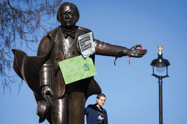 A student stands on the plinth of a statue of former Prime Minister David Lloyd George with climate change posters on the statue A student stands on the plinth of a statue of former Prime Minister David Lloyd George with climate change posters on the statue as a metaphor for picking fights with students ‘deflection strategy’ for ministers