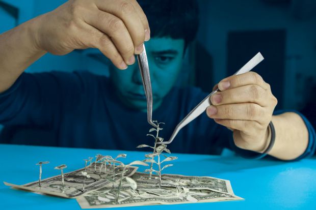 Man creating trees out of bank notes as metaphor for not all research used requires public money