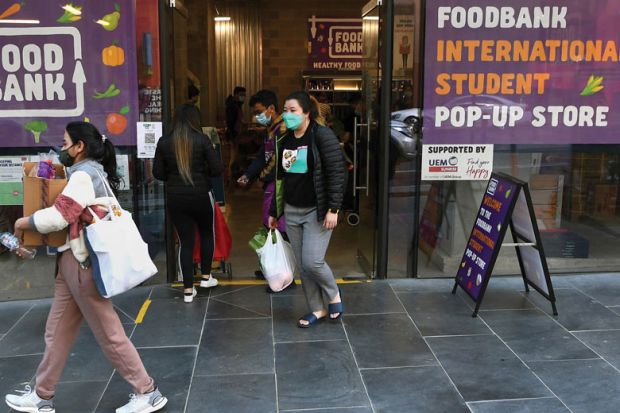 nternational students carry groceries from a foodbank in Melbourne to illustrate Covid spotlights hunger struggles for Australia’s overseas students
