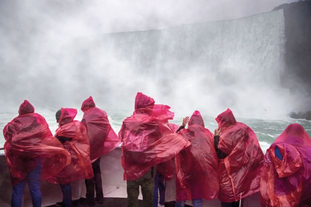 Tourists react to the water spray at at Niagara Falls, Ontario, Canada to illustrate Canada urged to drop English language tests for Nigerian students